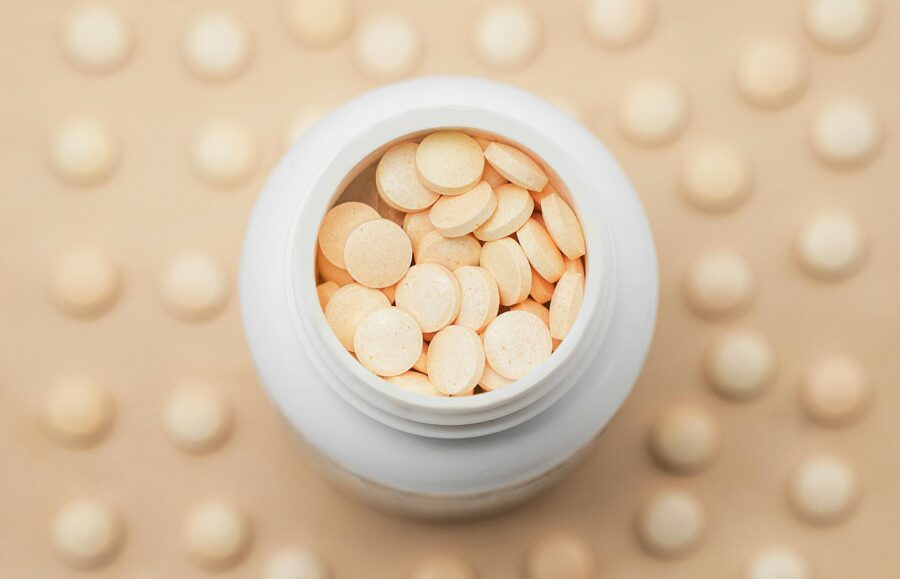 Top view of a white container filled with pills